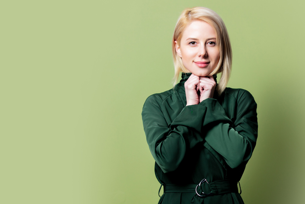 Woman Wearing Green Cloak on Green Background